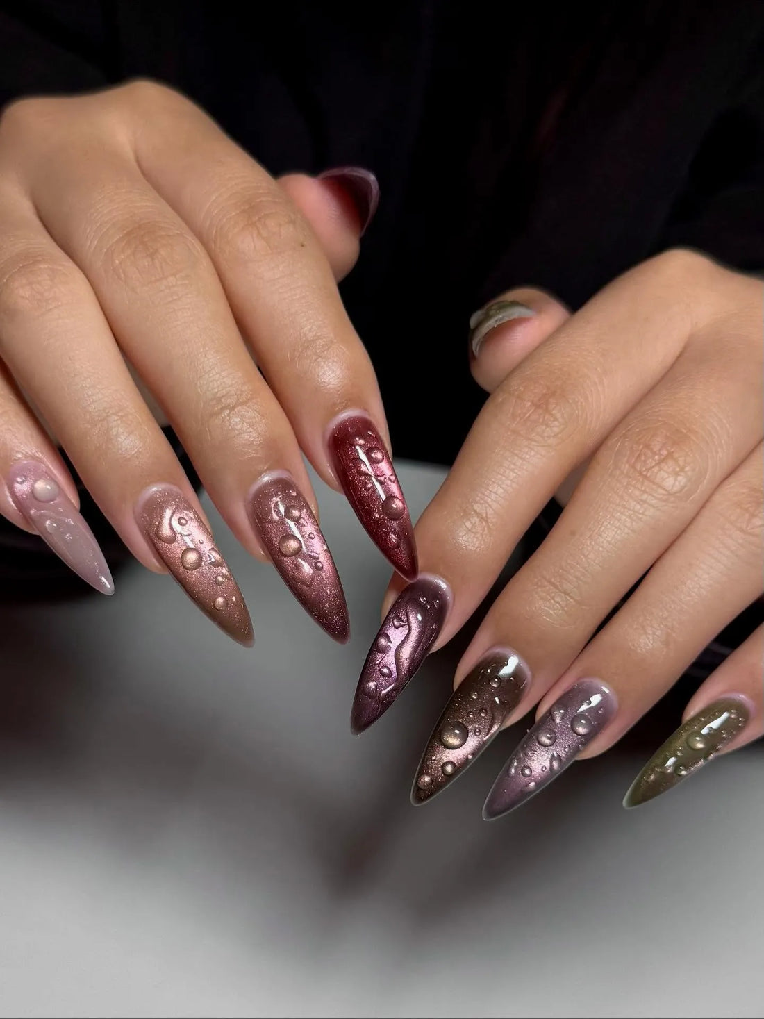 Handmade stiletto press-on nails with metallic cat-eye finish and 3D raindrop water effect