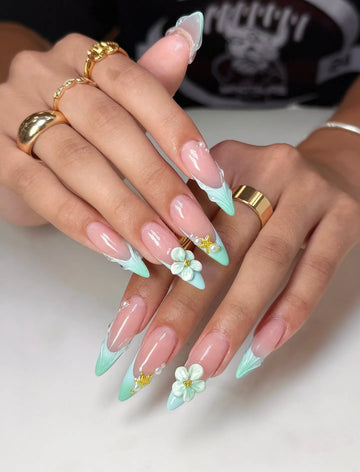 Hand with mint seafoam French tip press-on nails, 3D floral, pearl, and starfish accents