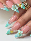 Hand with mint seafoam French tip press-on nails, 3D flowers, starfish, and pearl accents