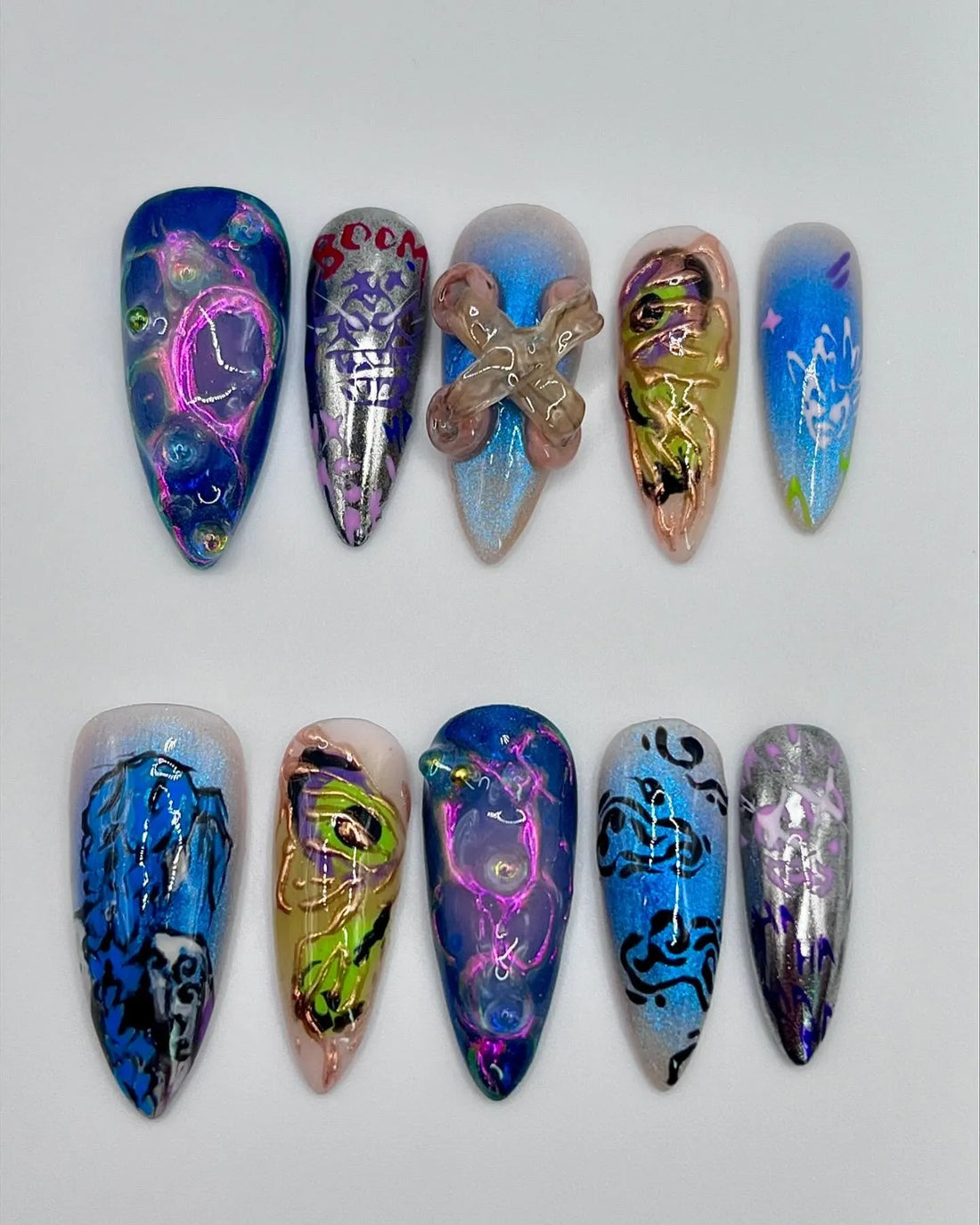 Handmade press-on nails with neon blue, chrome, abstract and grunge digital art designs.