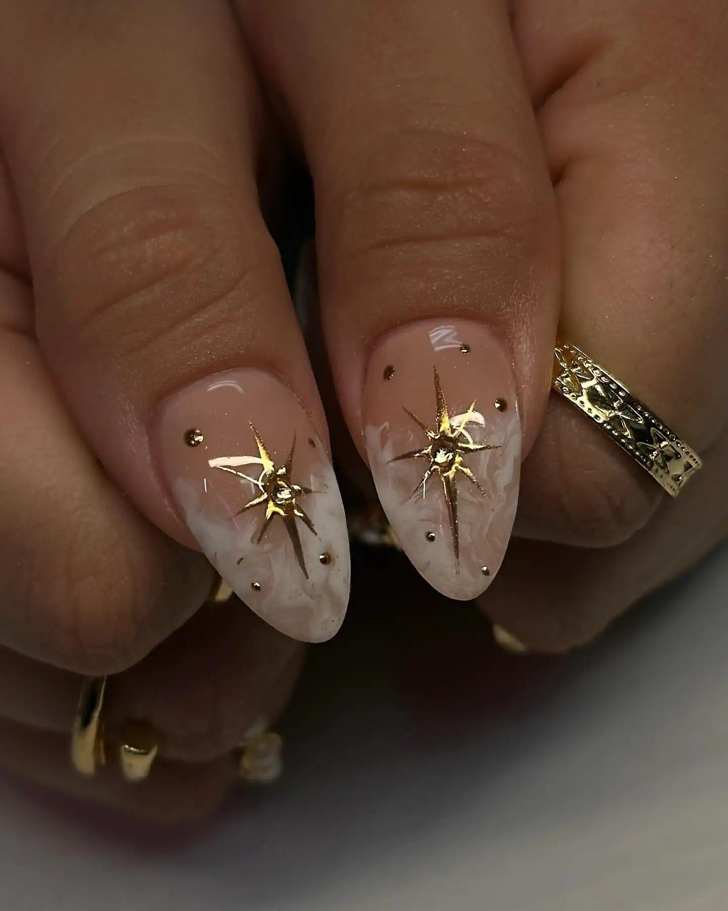 Handmade press-on nails with nude and soft smoke marbling, gold celestial heart charm accents