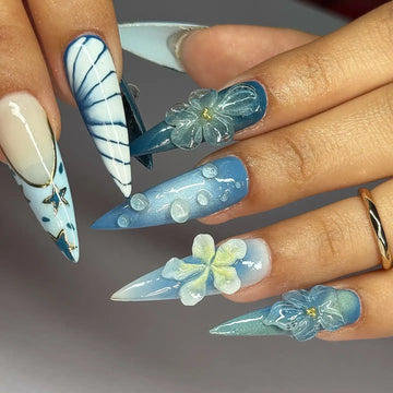 Handmade ocean blue ombre press-on nails with 3D floral, butterfly, and sky designs
