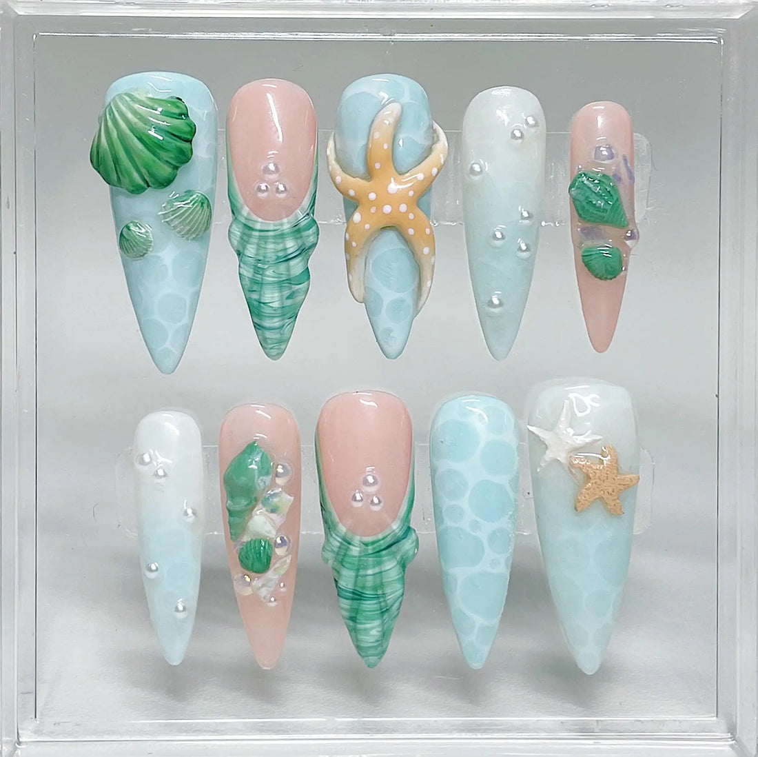Handmade ocean green press-on nails with 3D shell, starfish, and pearl beach designs.
