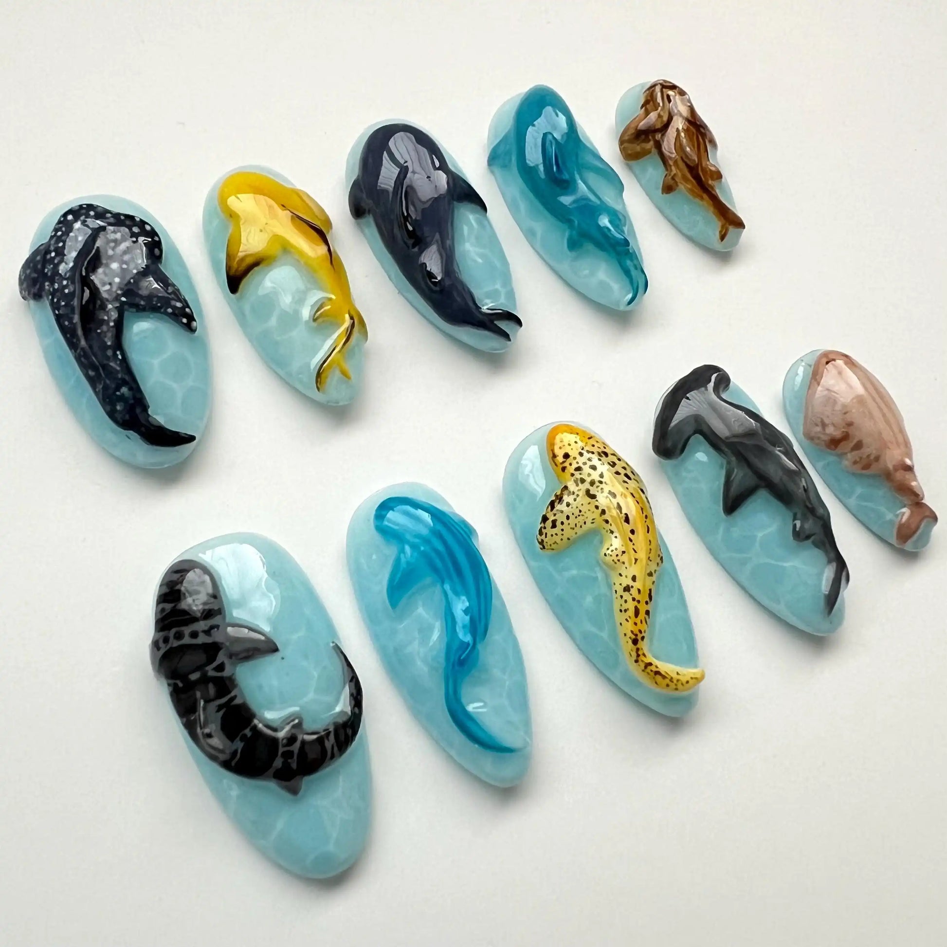 Handmade press-on nails with 3D ocean animal designs, featuring sharks, dolphins, and whales.