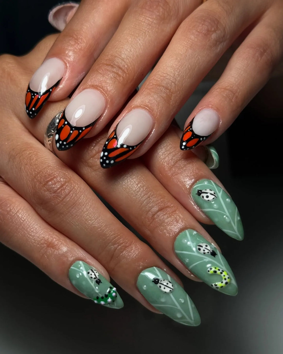 Handmade press-on nails with orange monarch butterfly and green beetle nature designs
