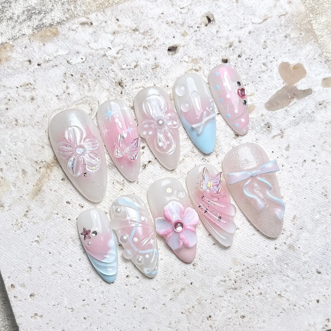 Handmade pastel press-on nails with butterfly, bow, pearl, and flower 3D designs