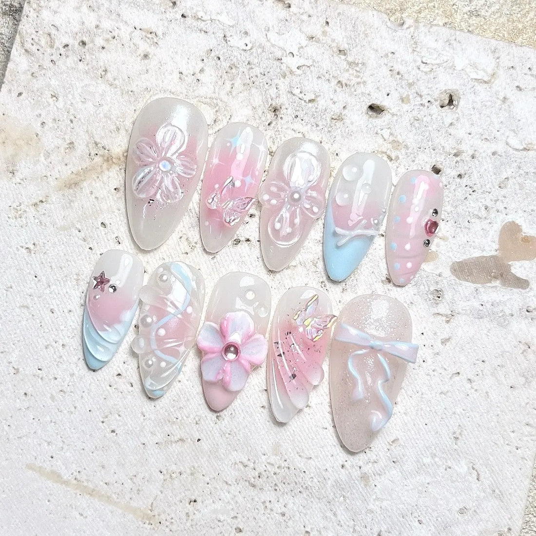 Handmade pastel press-on nails with butterfly, bow, pearl, and flower 3D designs
