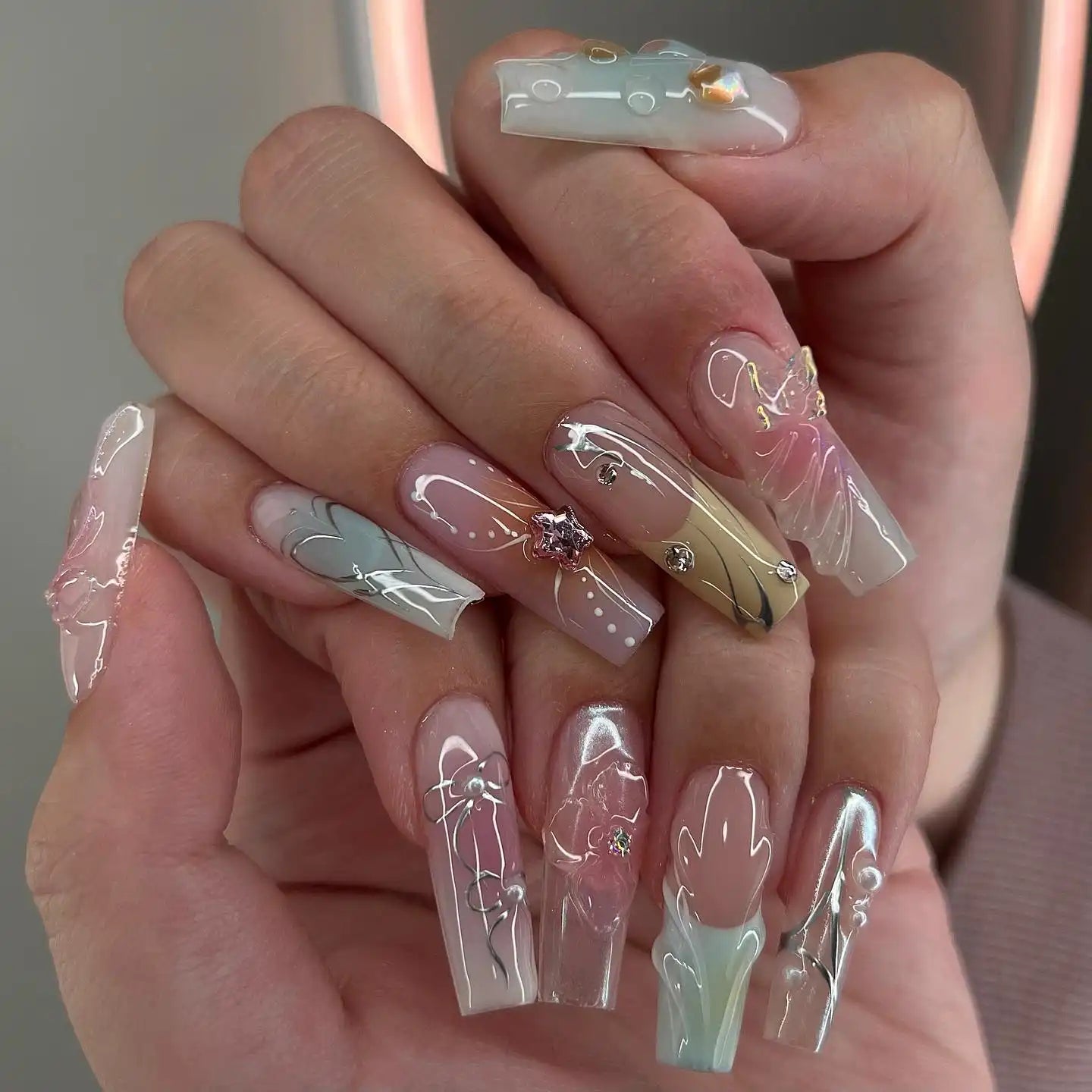 Handmade pastel chrome press-on nails with 3D floral designs and rhinestone accents