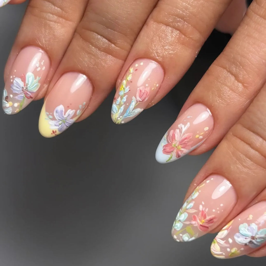 Handmade pastel floral French tip press-on nails with spring watercolor garden design.