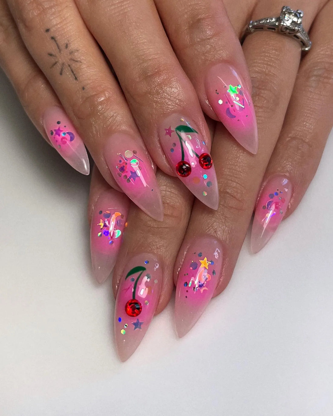Handmade extra long stiletto press-on nails with pink aura, cherry and celestial glitter designs