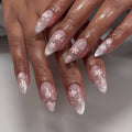 Handmade press-on nails with pink cherry blossom design and silver glitter French ombre tips.