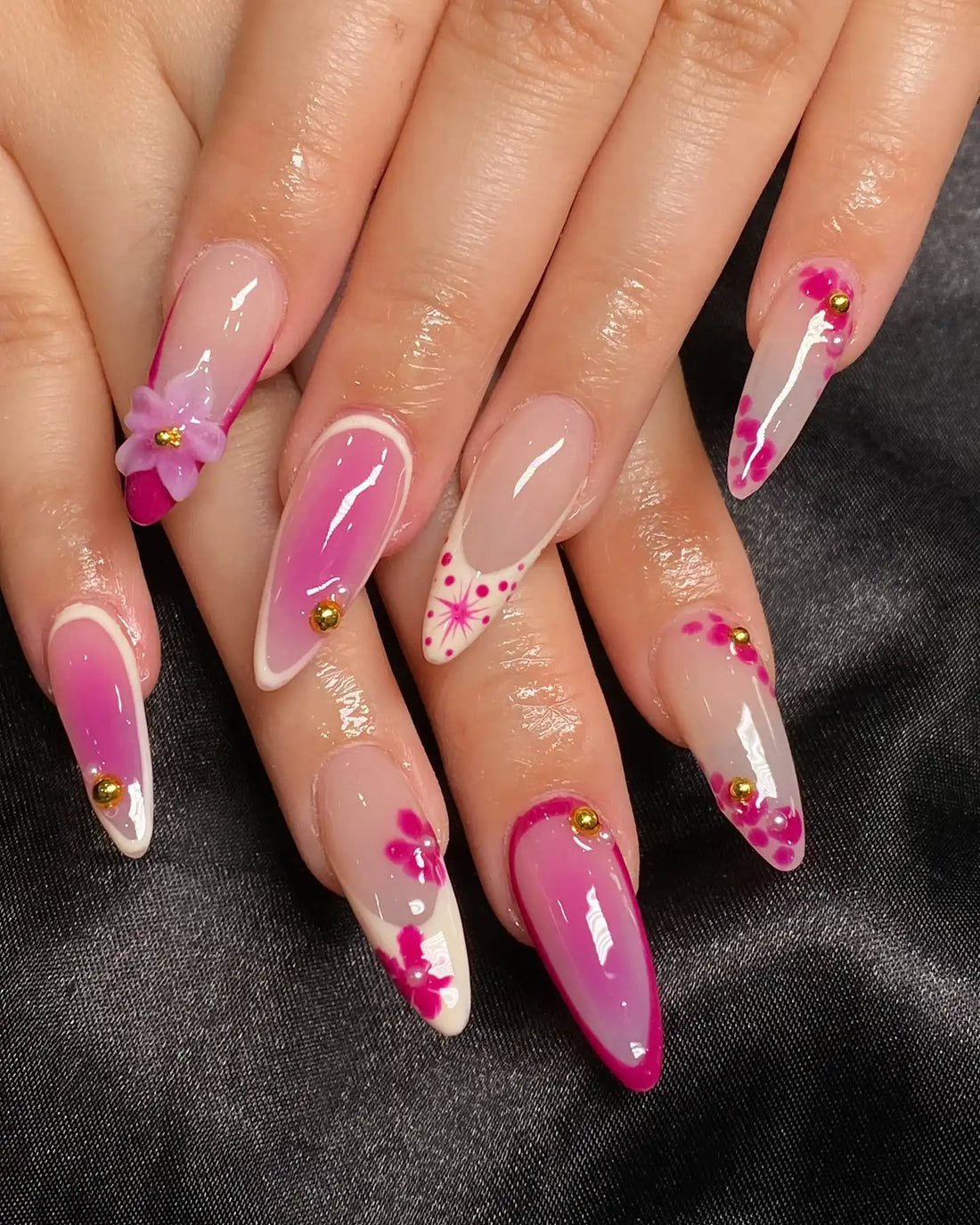 Handmade pink floral 3D flower press-on nails with gold accents on almond-shaped tips