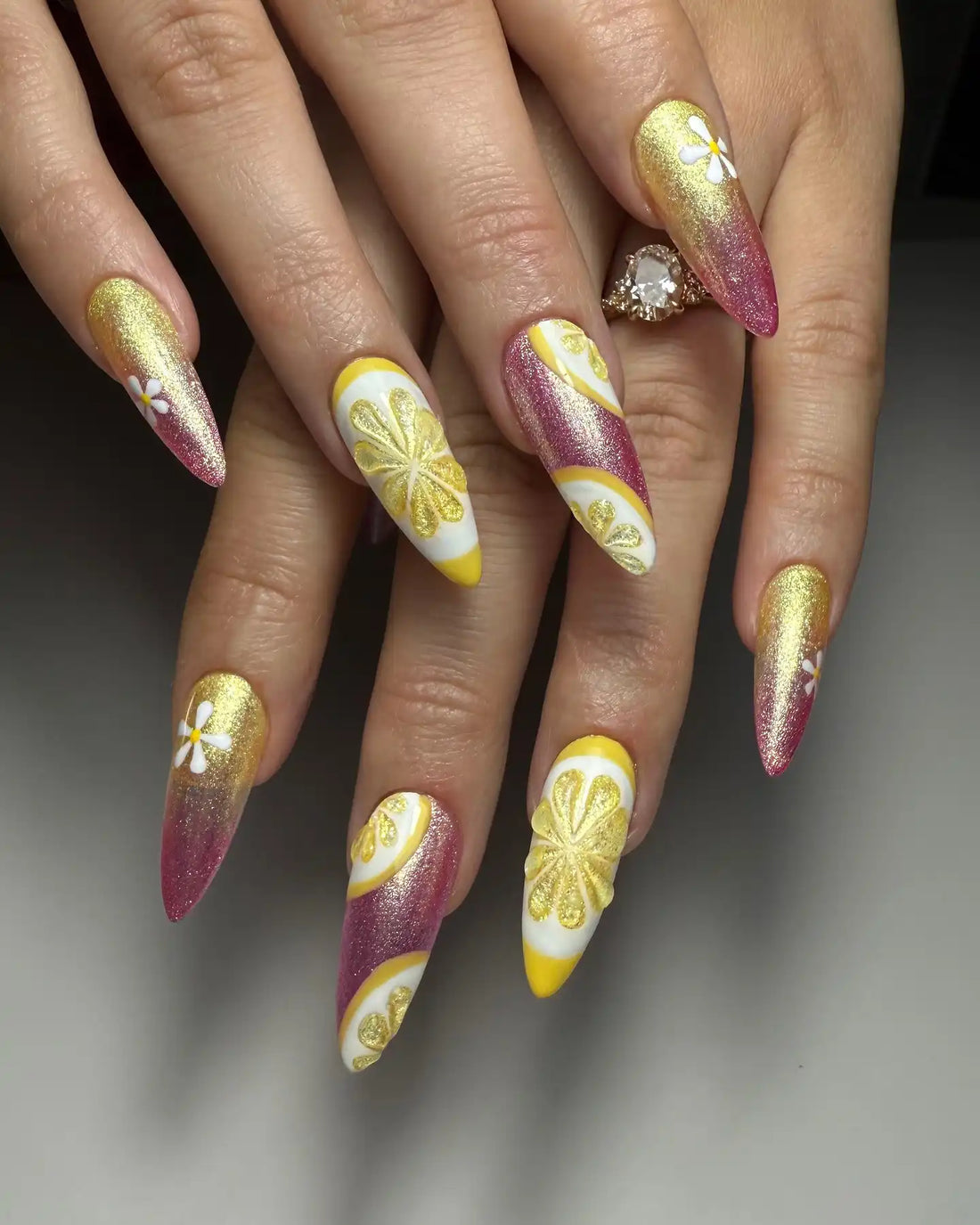 Handmade stiletto press-on nails with pink, gold, and lemon citrus nail art accents.