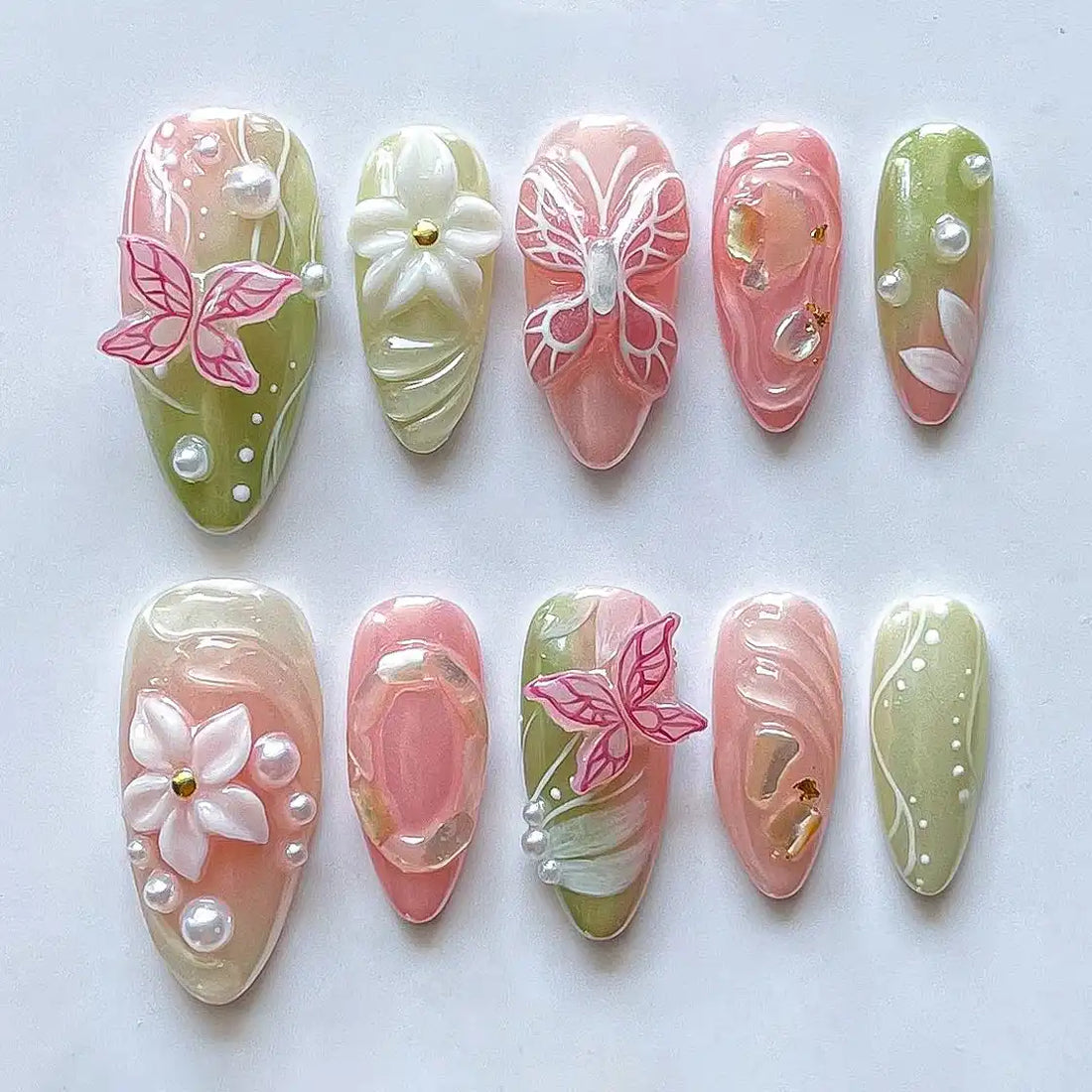 Handmade pink and green press-on nails with 3D butterfly, floral, pearl, and spring designs.
