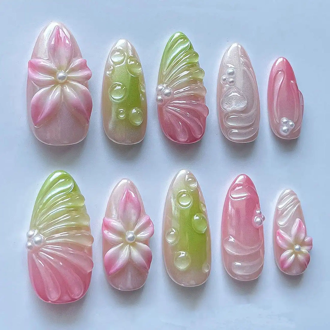 Handmade press-on nails with pink and green flower, pearl, and dew drop spring designs