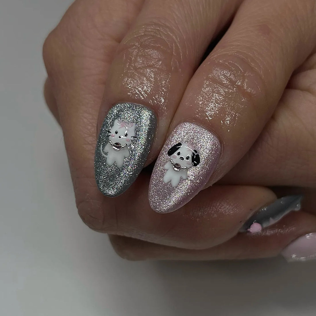 Handmade pink and grey press-on nails with chrome, glitter, 3D heart and star Y2K designs.