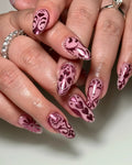 Handmade pink chrome press-on nails with heart and folk art designs