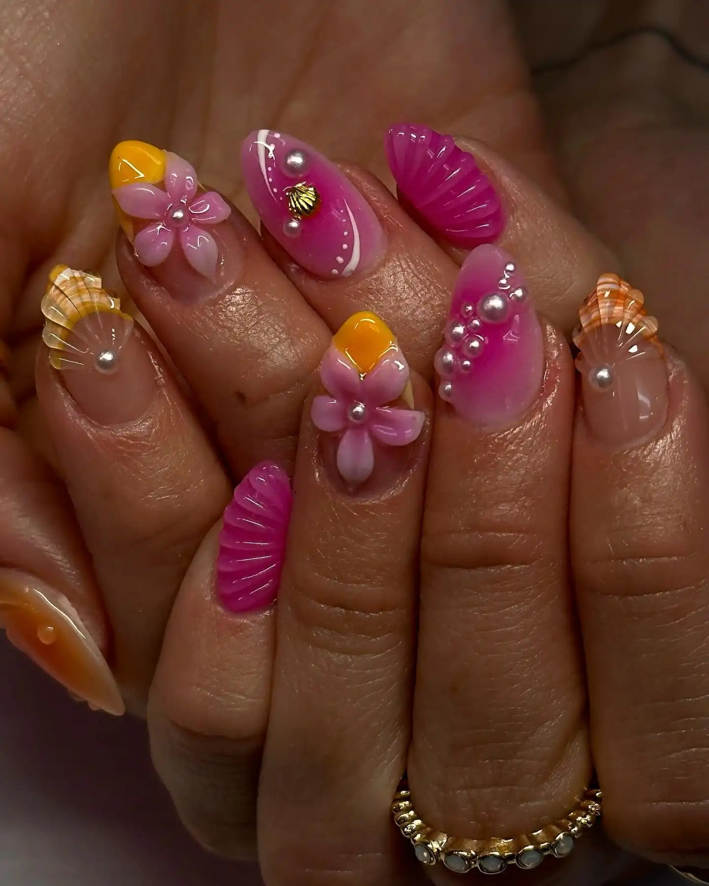 Handmade press-on nails with 3D pink flowers, pearls, and summer beach shell designs.