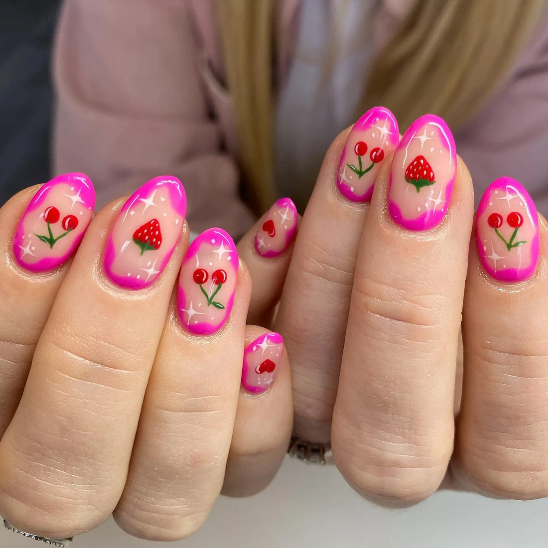 Handmade pink sparkle press-on nails with strawberry and cherry fruit art design