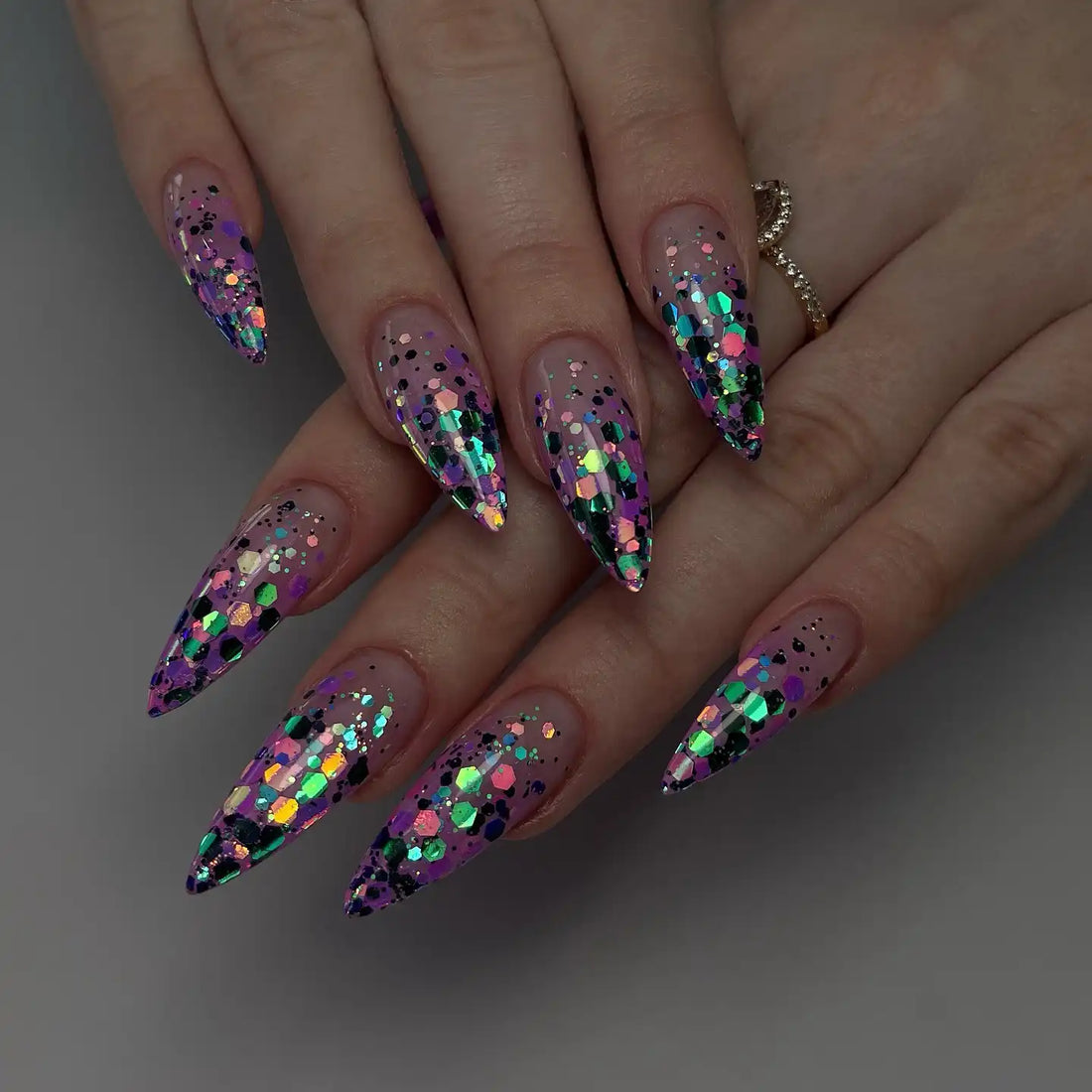 Handmade purple holographic galaxy glitter press-on nails with stiletto shape