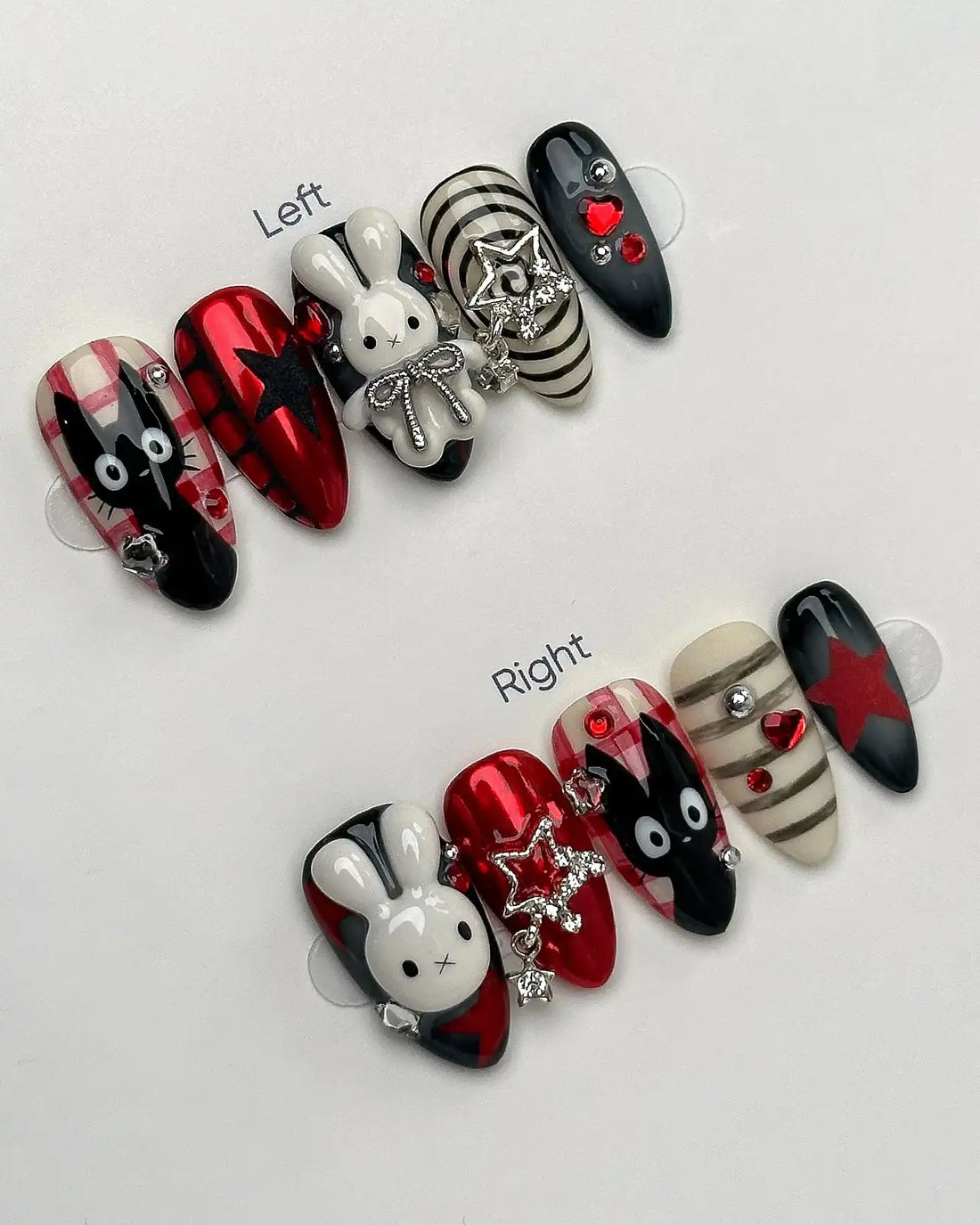 Handmade press-on nails featuring bunny, cat, plaid, checkerboard, and star designs in red, black, and white with 3D charms.