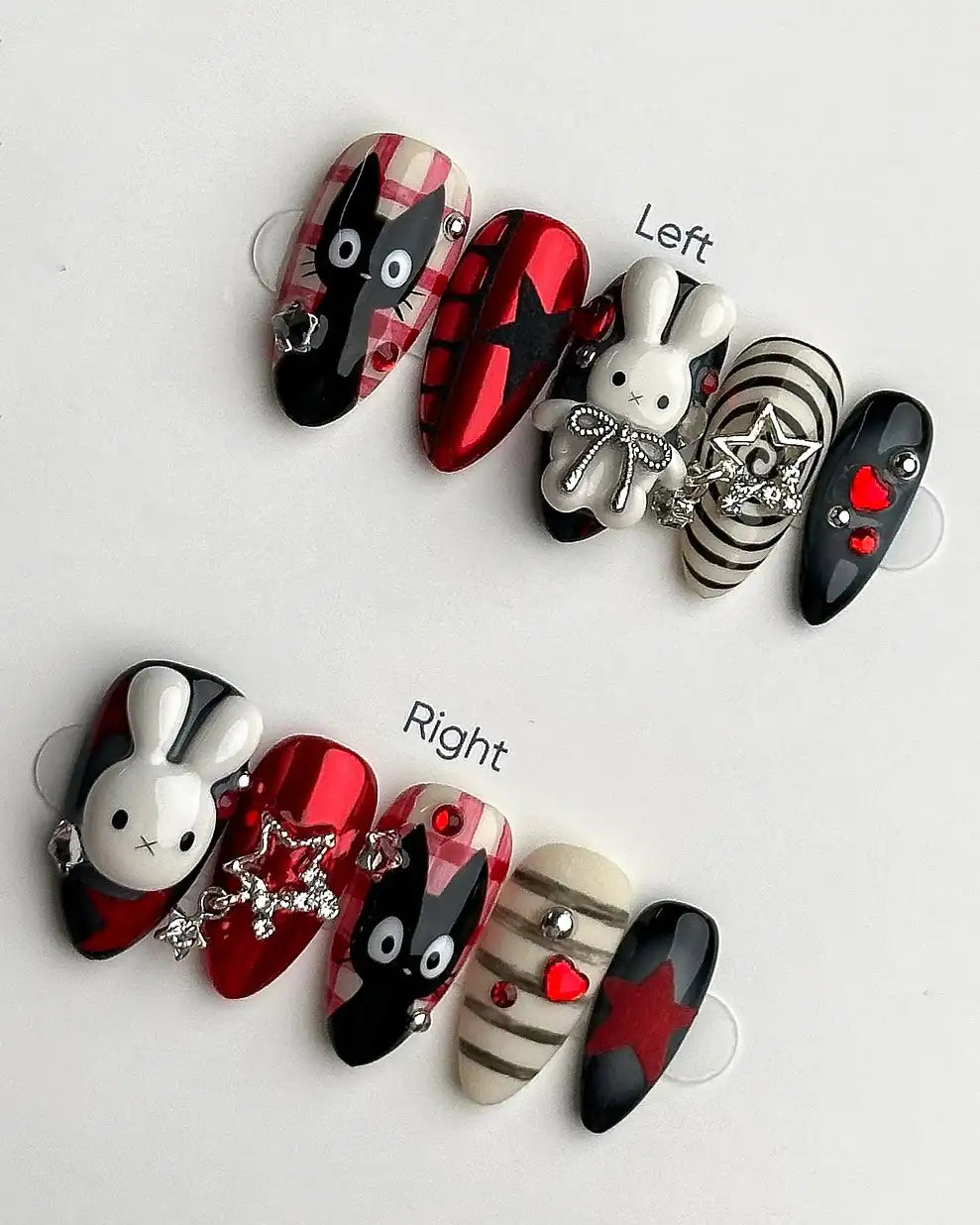 Handmade press-on nails featuring bunny, cat, plaid, checkerboard, and star designs in red, black, and white with 3D charms.