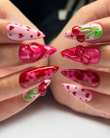 Handmade press-on nails with pink, red cherry, heart, floral, and 3D bow designs.