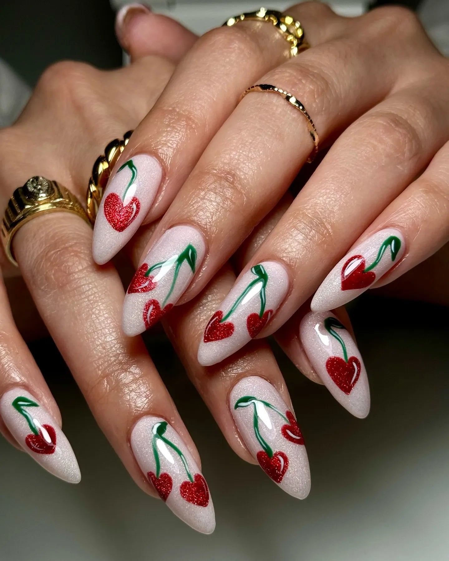 Handmade press-on nails with red glitter heart cherry design on white shimmer base