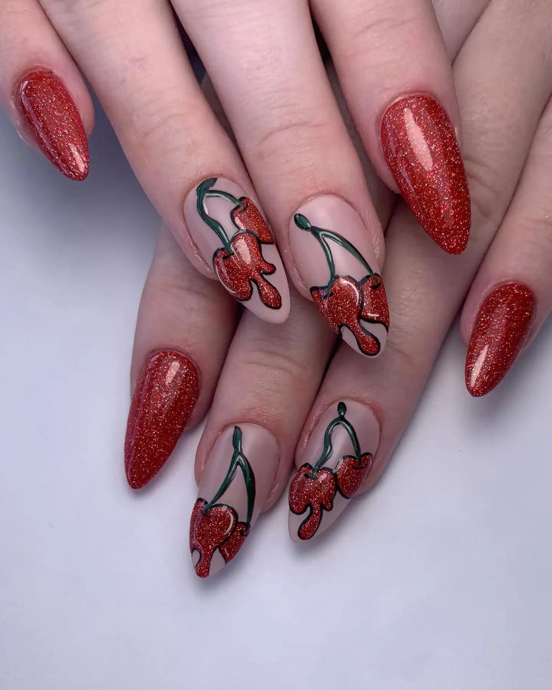 Handmade red glitter press-on nails with melting cherry summer fruit nail art design.