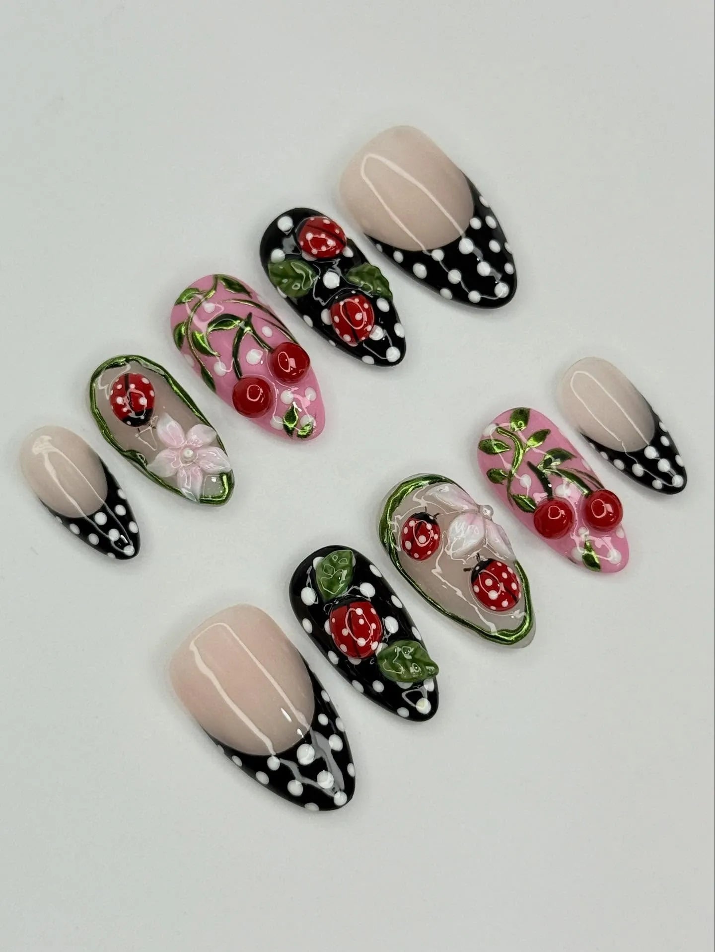 Handmade press-on nails with red ladybug, cherry, and polka dot 3D garden designs