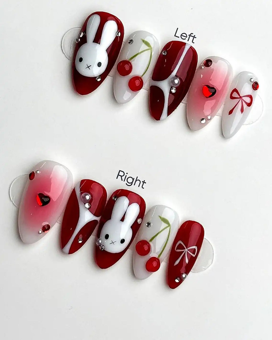 Handmade red and white press-on nails with bunny, cherry, bow, and heart designs.