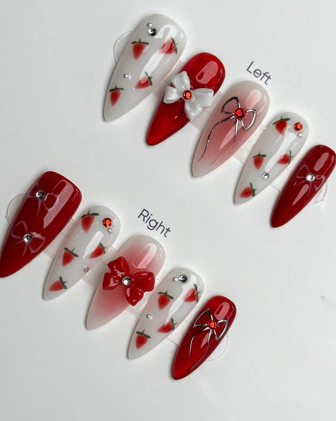 Handmade red and white press-on nails with strawberry, bow, and jewel accents, summer design
