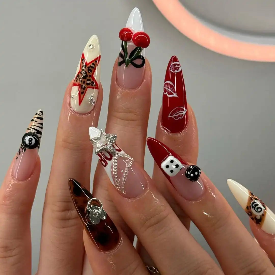 Handmade stiletto press-on nails with red, brown, cherry, dice, star, and leopard designs