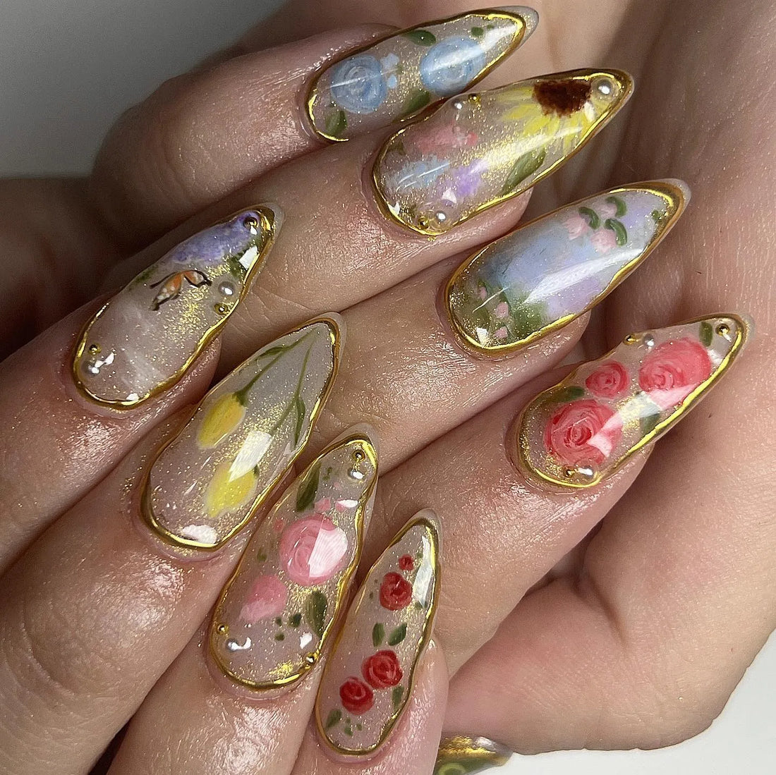 Handmade spring garden floral press-on nails with gold leaf details and rose designs