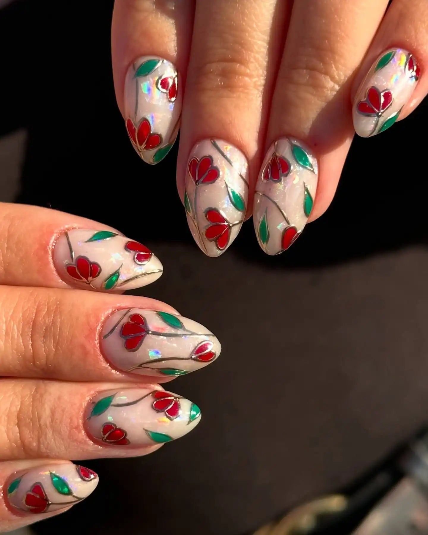 Handmade press-on nails with stained glass effect, red floral and green leaf design