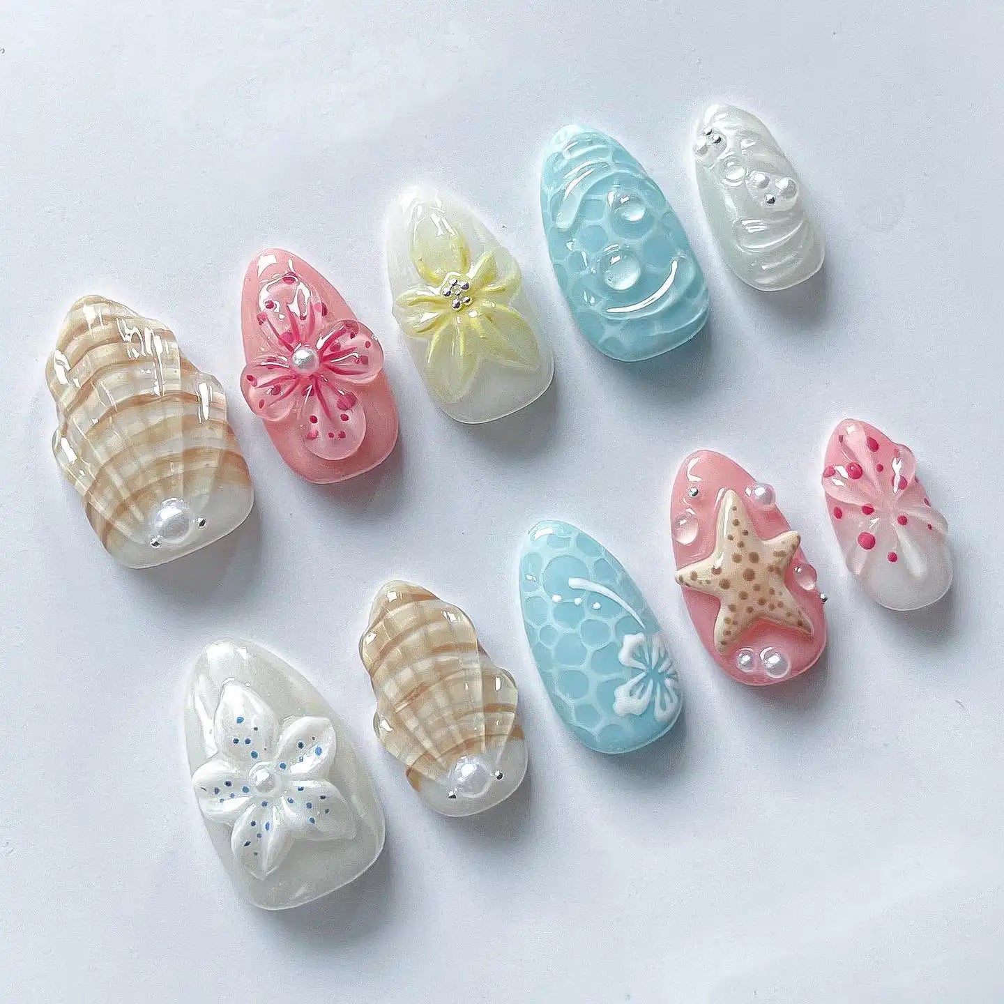 Handmade press-on nails with starfish, seashell, and floral pastel beach designs