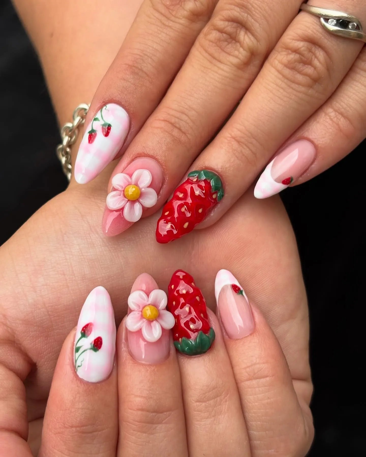Handmade press-on nails with 3D strawberries, floral accents, and pink French tips.