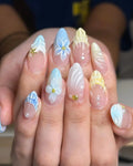 Handmade press-on nails with blue and yellow 3D floral and seashell mermaid designs