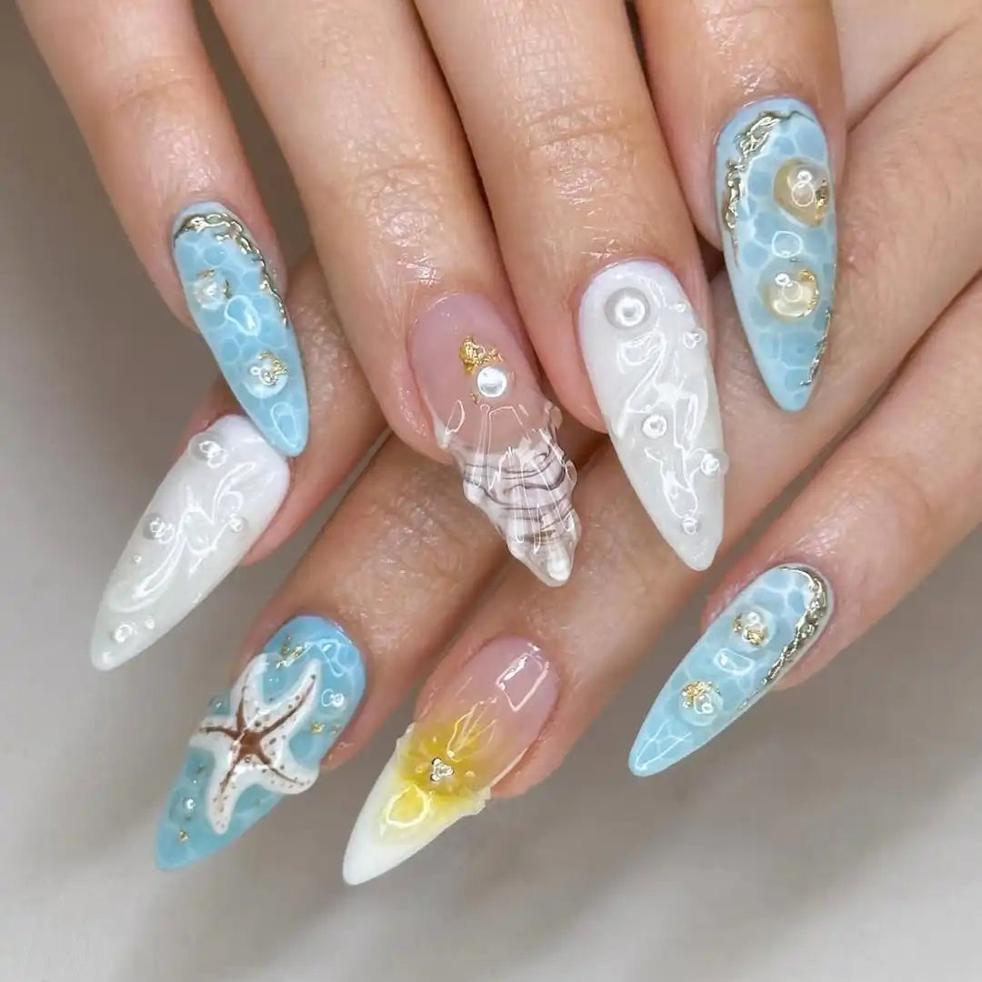 Handmade beach-themed press-on nails with starfish, seashell, pearl and ocean designs