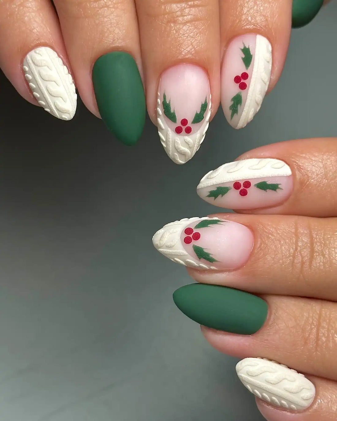 Handmade green press-on nails with white sweater texture and holly berry Christmas design.