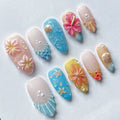 Handmade tropical press-on nails with 3D flowers, shells, pearls, and vibrant beach designs