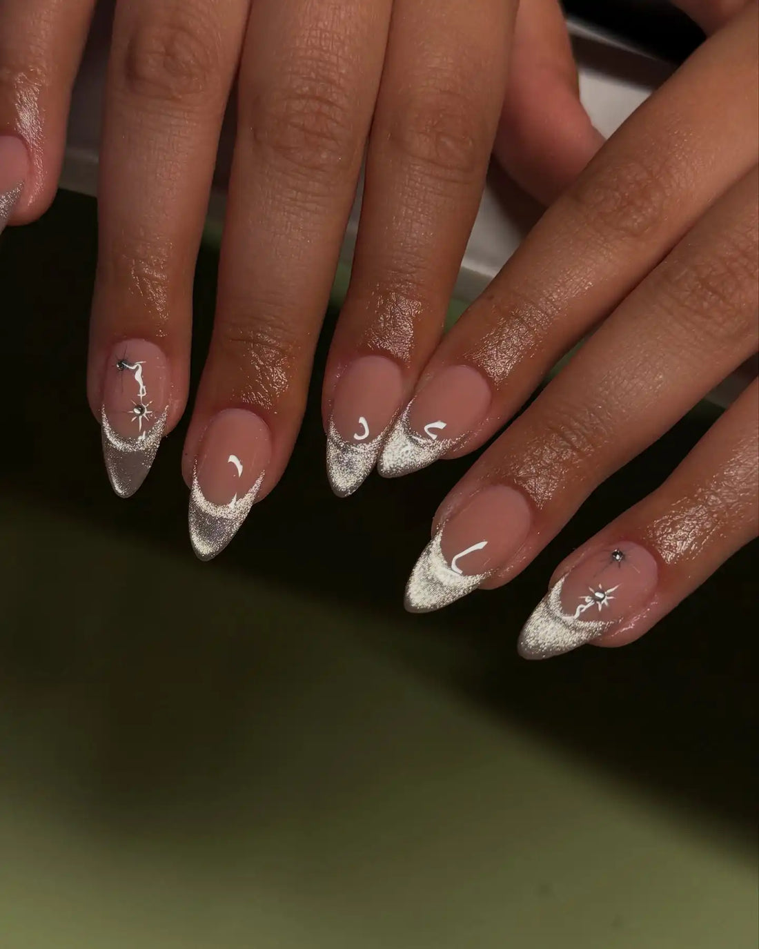 Handmade press-on nails with white cat eye and silver glitter French tips, almond shape