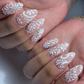 Handmade white lace floral swirl press-on nails with elegant bridal wedding design.