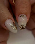 Handmade white press-on nails with glossy gold 3D floral accent design