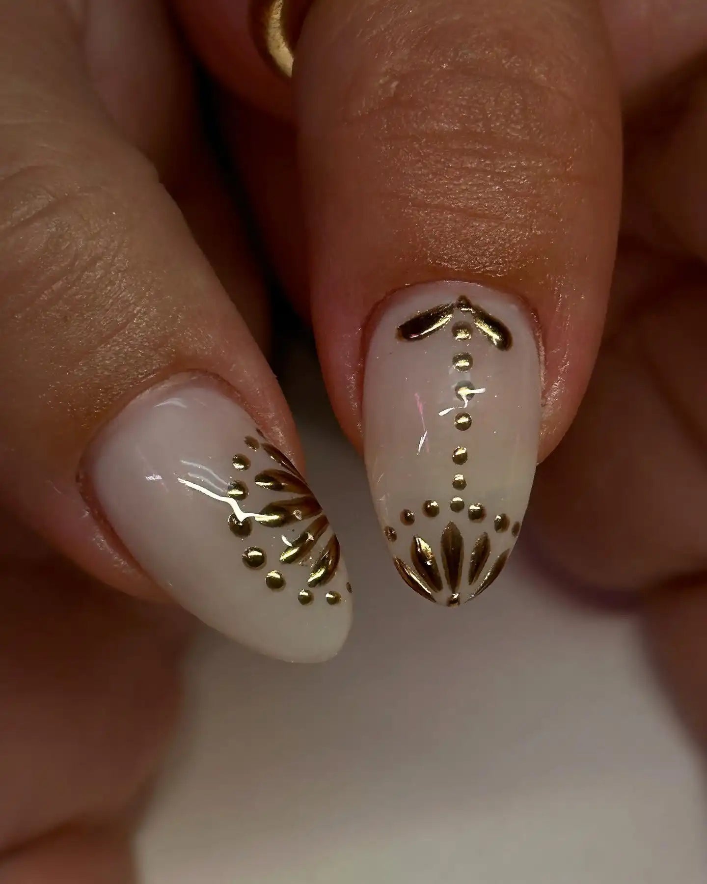 Handmade white press-on nails with glossy gold 3D floral accent design
