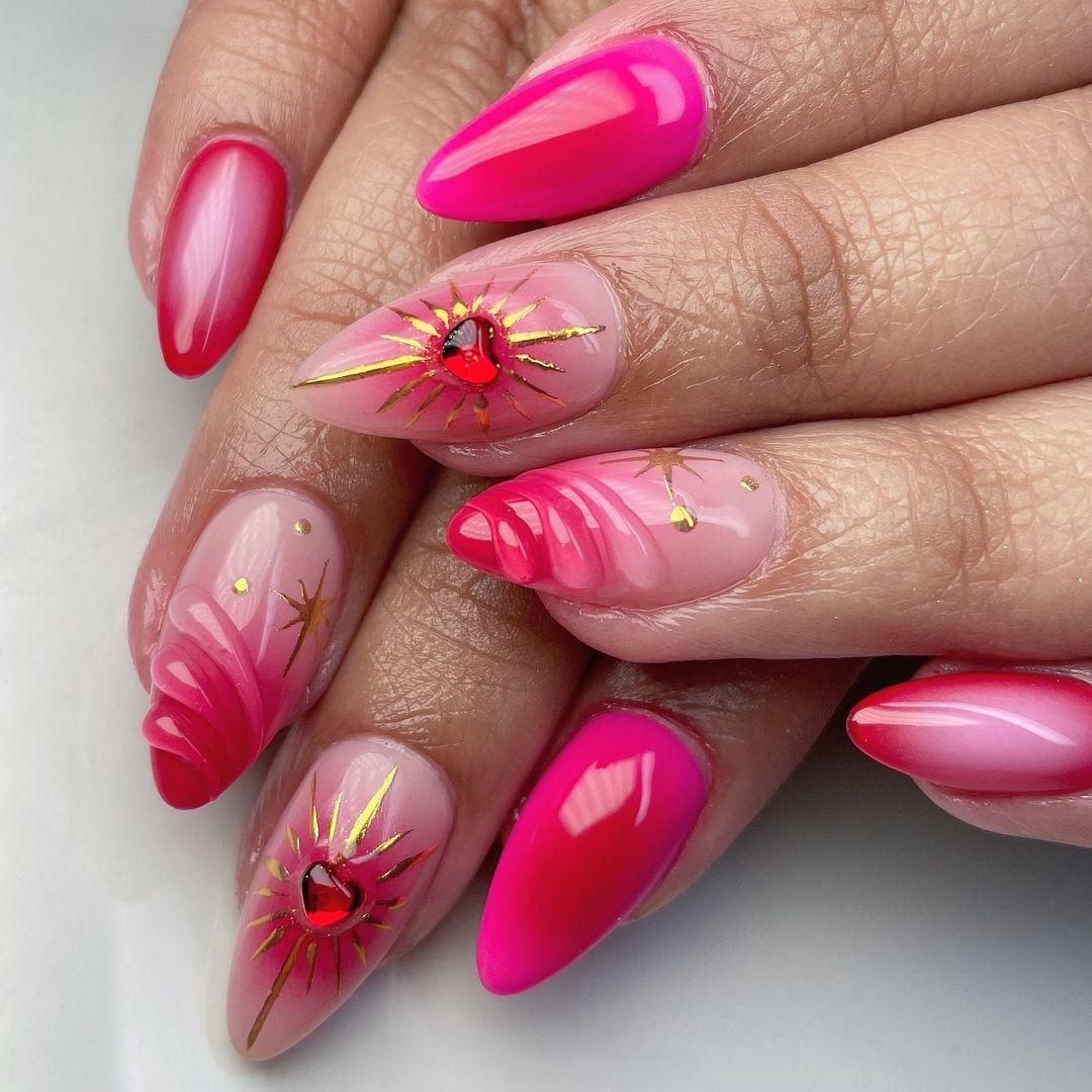Hand with pink press-on nails, heart and star nail art, almond shape, glossy finish.