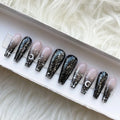 Handmade press-on nails with black ombre, glitter, moon and star designs in a gift box
