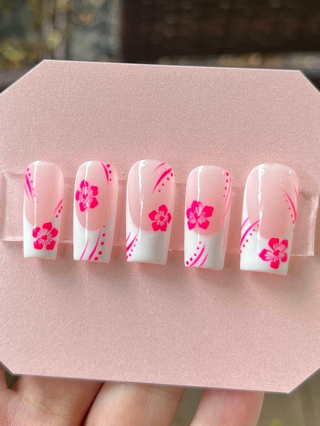 Handmade pink floral press-on nails with white tips and pink flower designs